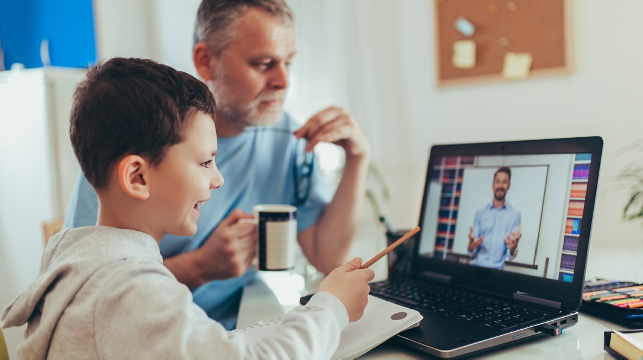 Schoolboy educate online. Father helps his son with home work. Boy in video conference with teacher on laptop at home.  (Schoolboy educate online. Father helps his son with home work. Boy in video conference with teacher on laptop at home. , ASCII, 12